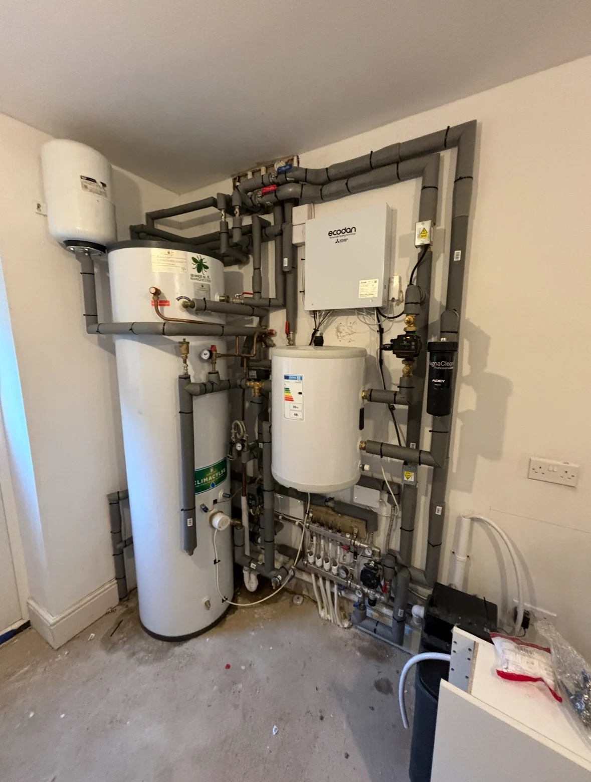 Hot-water cylinder and fitted pipework
